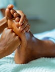 a person laying in a bed with their feet up