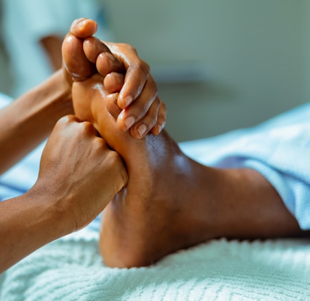 a person laying in a bed with their feet up