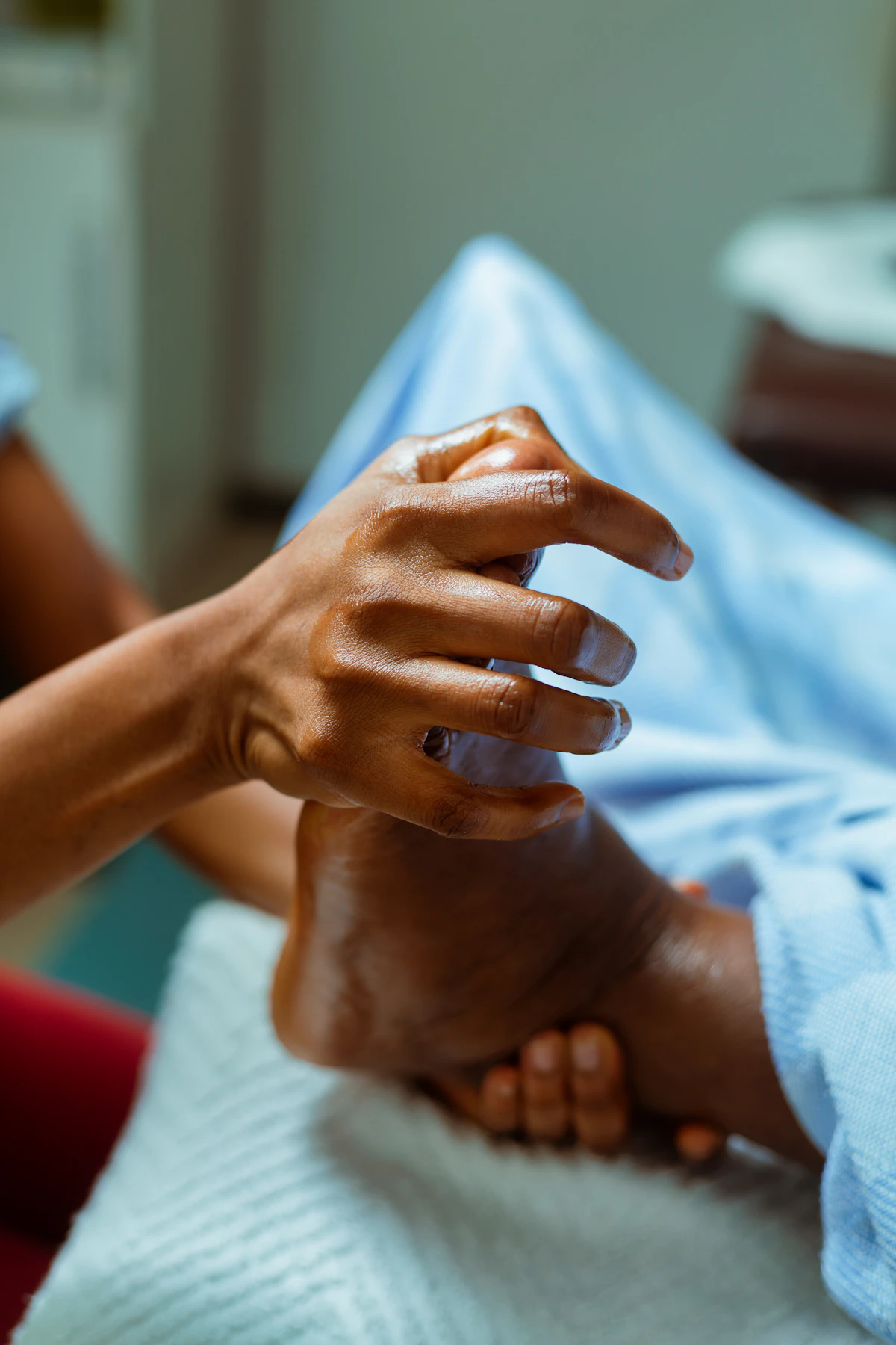 A person holding another person's hand in a hospital bed for support during labor.