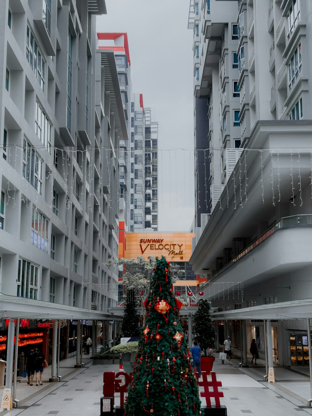 a christmas tree is in the middle of a shopping mall