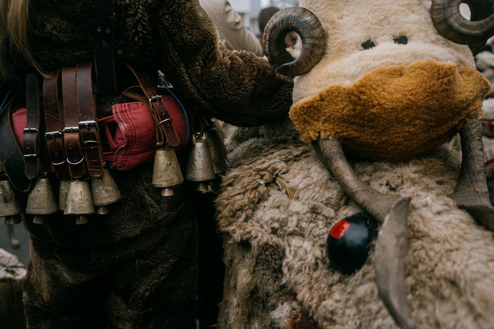 a stuffed animal with horns and bells on it's back