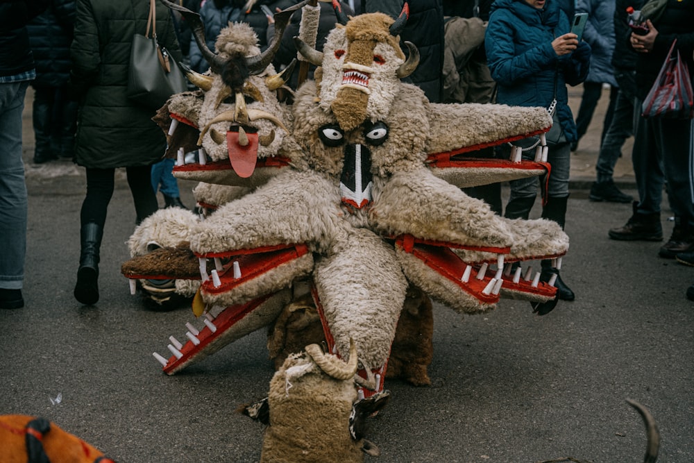 a group of people standing around a group of stuffed animals