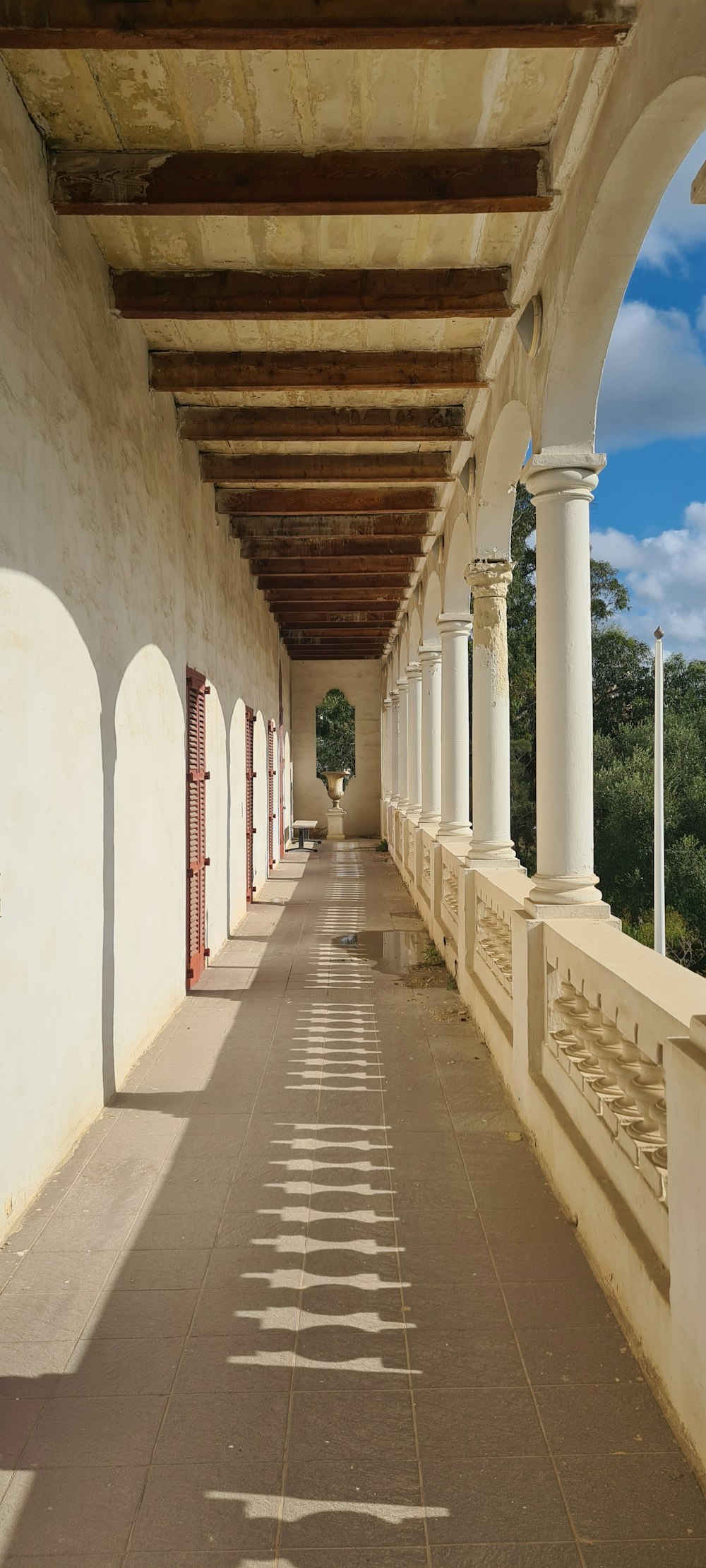 a long walkway lined with columns and pillars