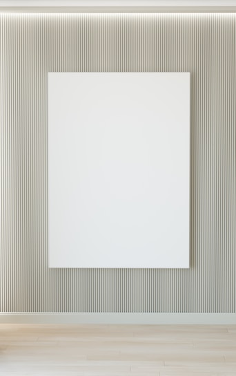 A skilled craftsman carefully applying finishing touches on a modern minimalist interior wall.