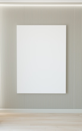 A minimalist interior featuring a large blank white canvas on a wall with vertical grooves. The floor is wooden, and there's soft lighting from above.