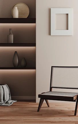 A minimalist living room featuring a handcrafted wooden chair with heritage-inspired carvings.