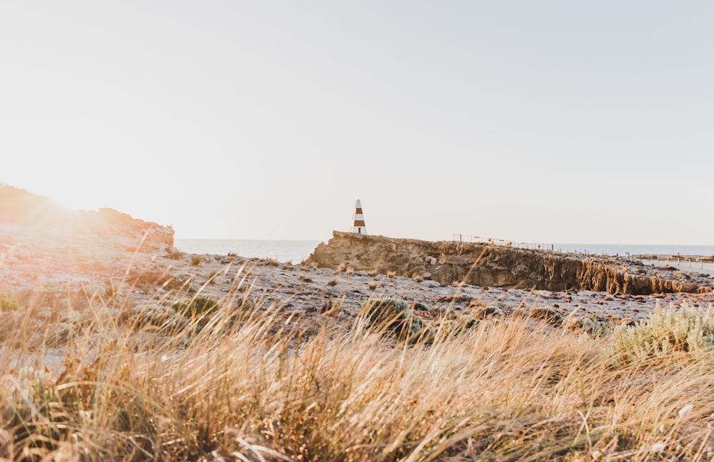 a light house sitting on top of a cliff near the ocean