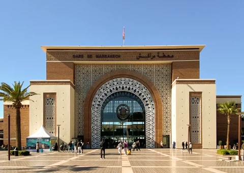Gare ferroviaire marocaine avec quai et train, illustrant le trajet en train de l'aéroport de Casablanca vers Rabat