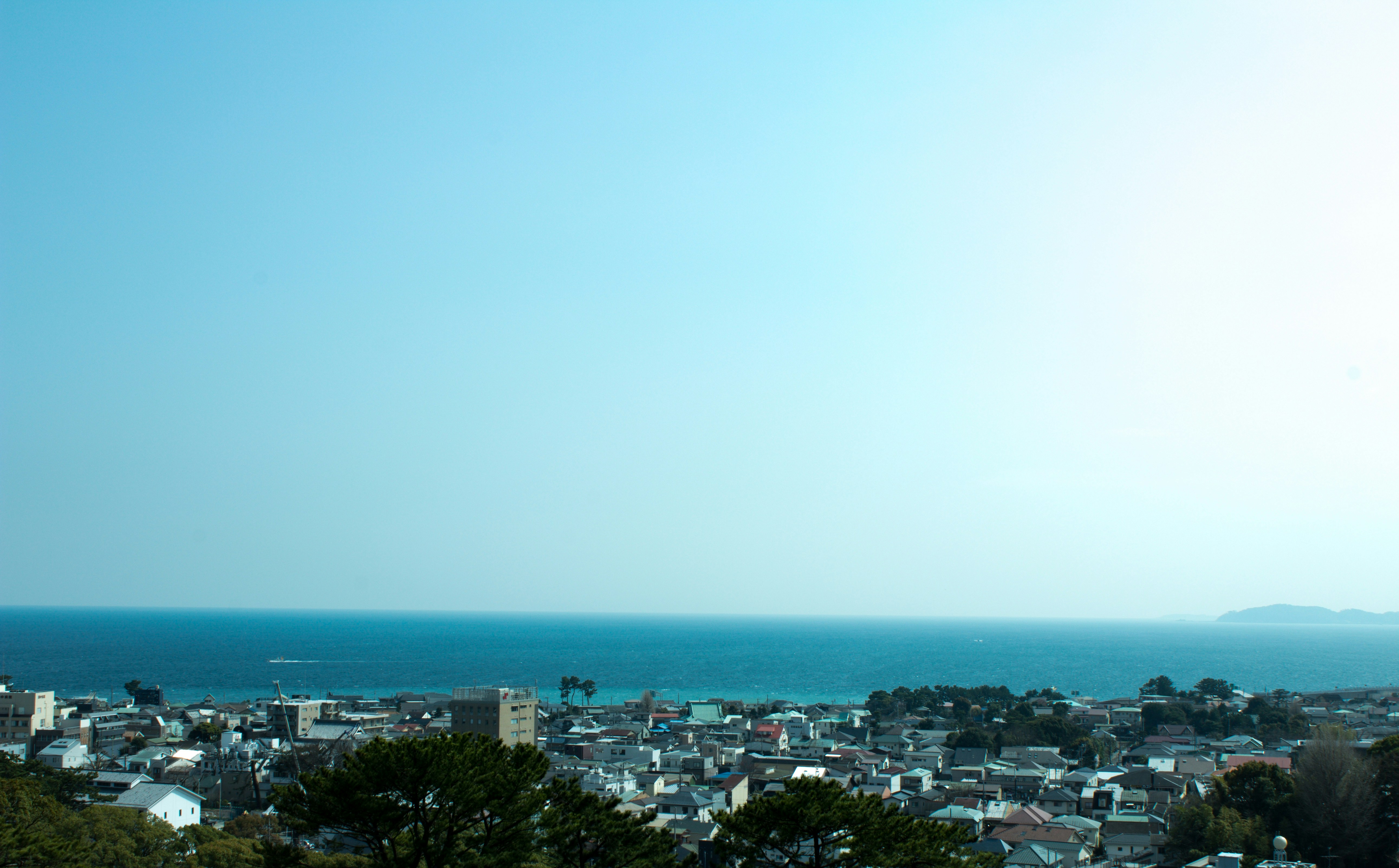 a view of a city with a body of water in the background