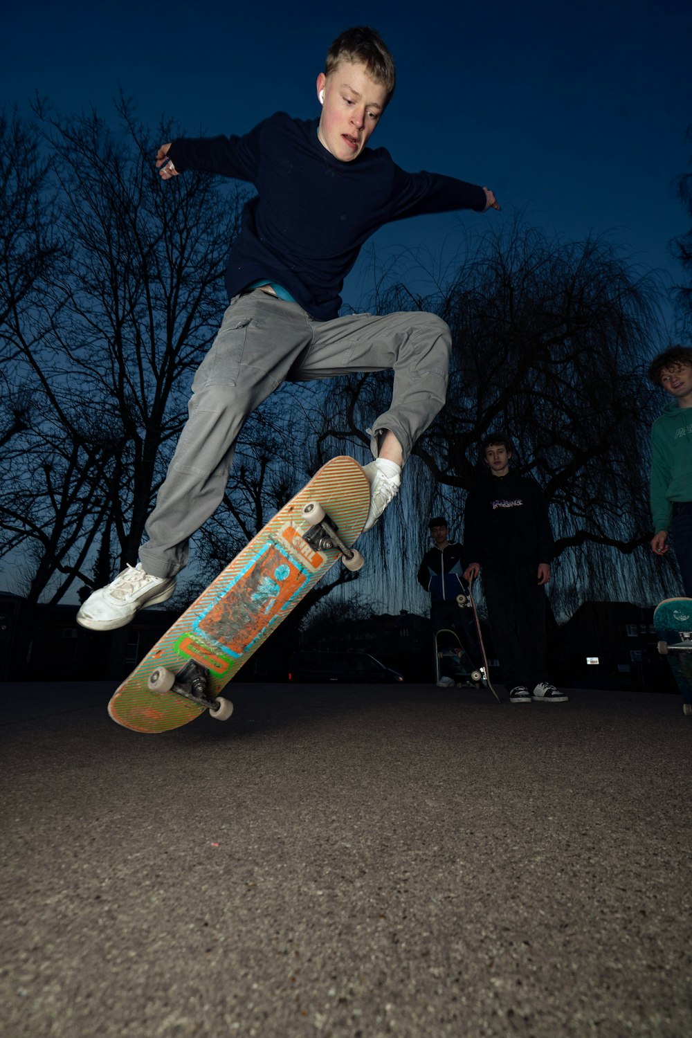 a boy is doing a trick on a skateboard