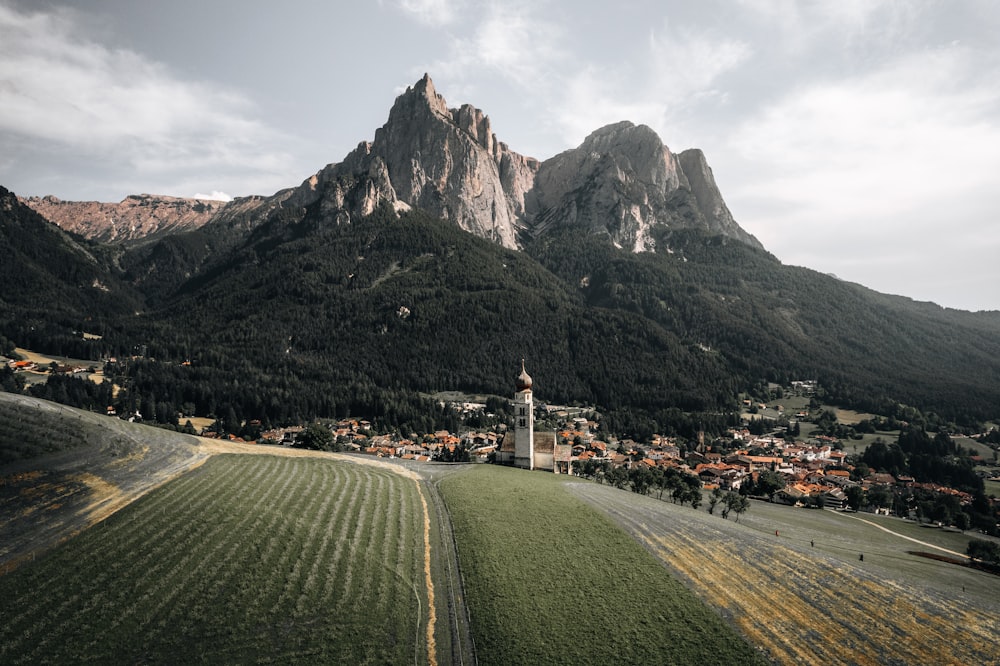 a scenic view of a small town in the mountains