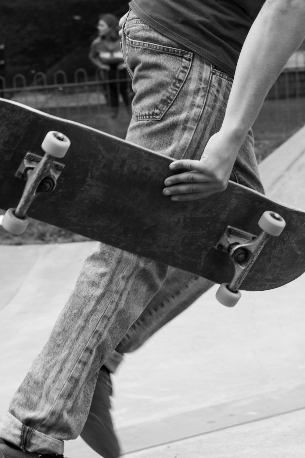 a person holding a skateboard in their hand