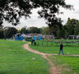 Community park design integrating playgrounds and walking paths.