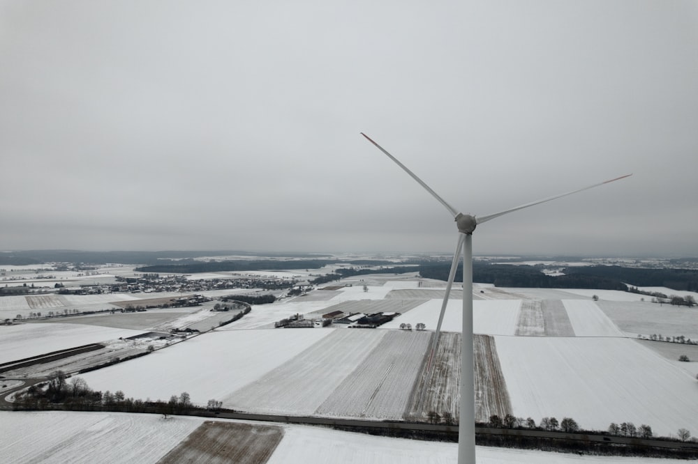 an aerial view of a wind farm in the snow