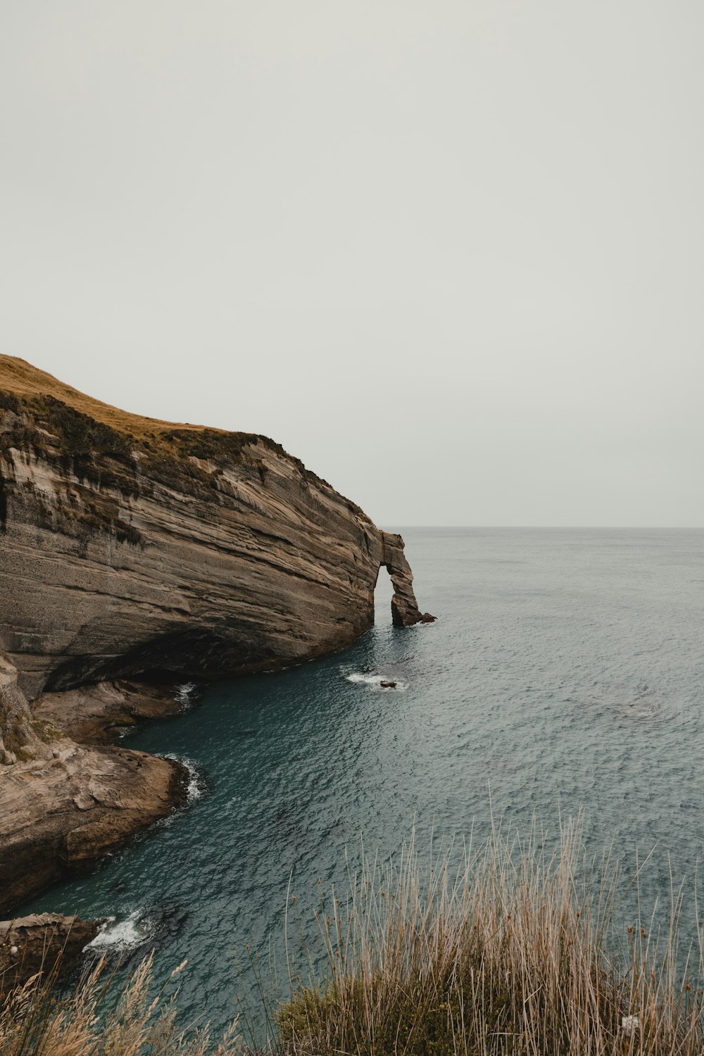 a large body of water next to a cliff