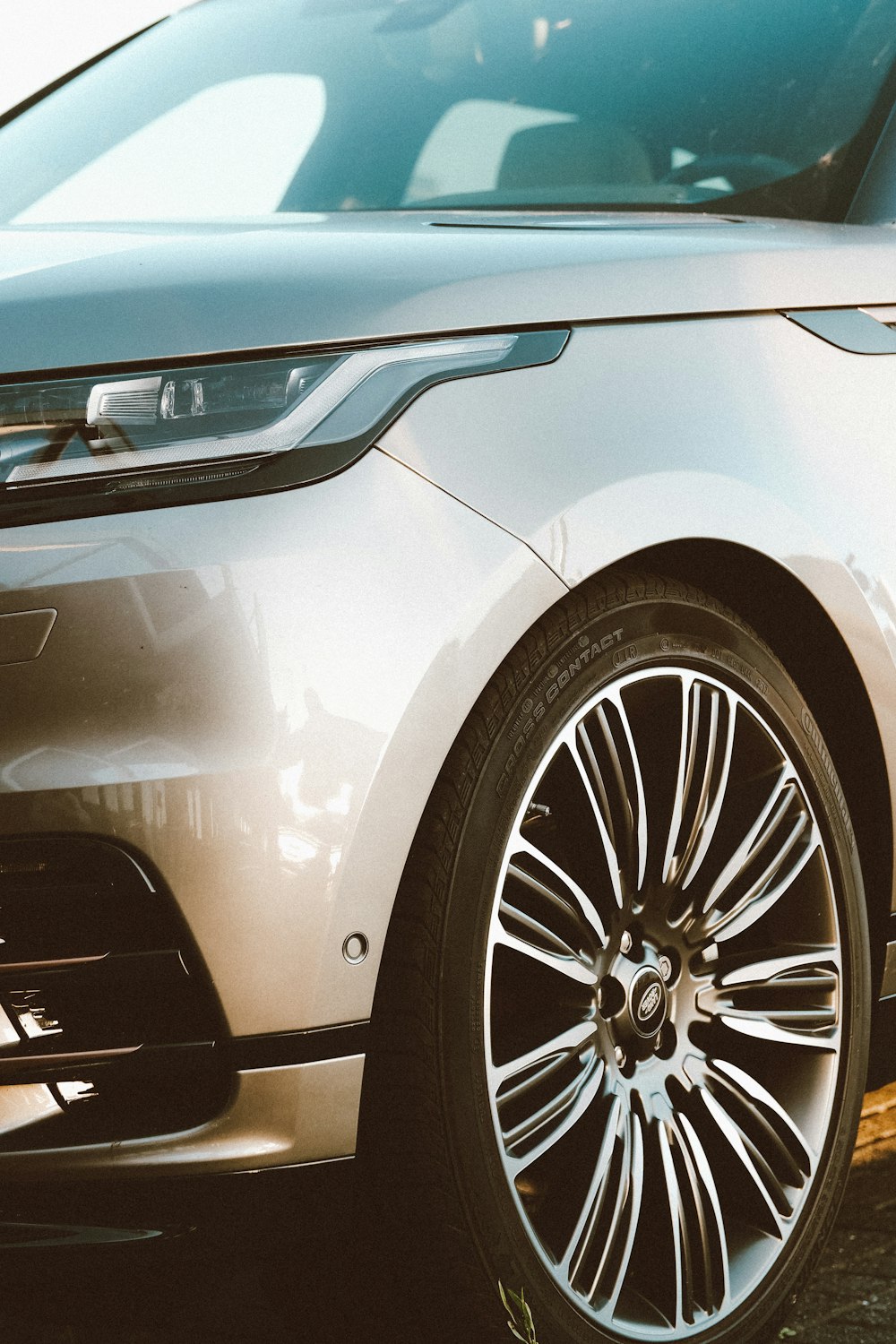 a silver range rover parked in a parking lot