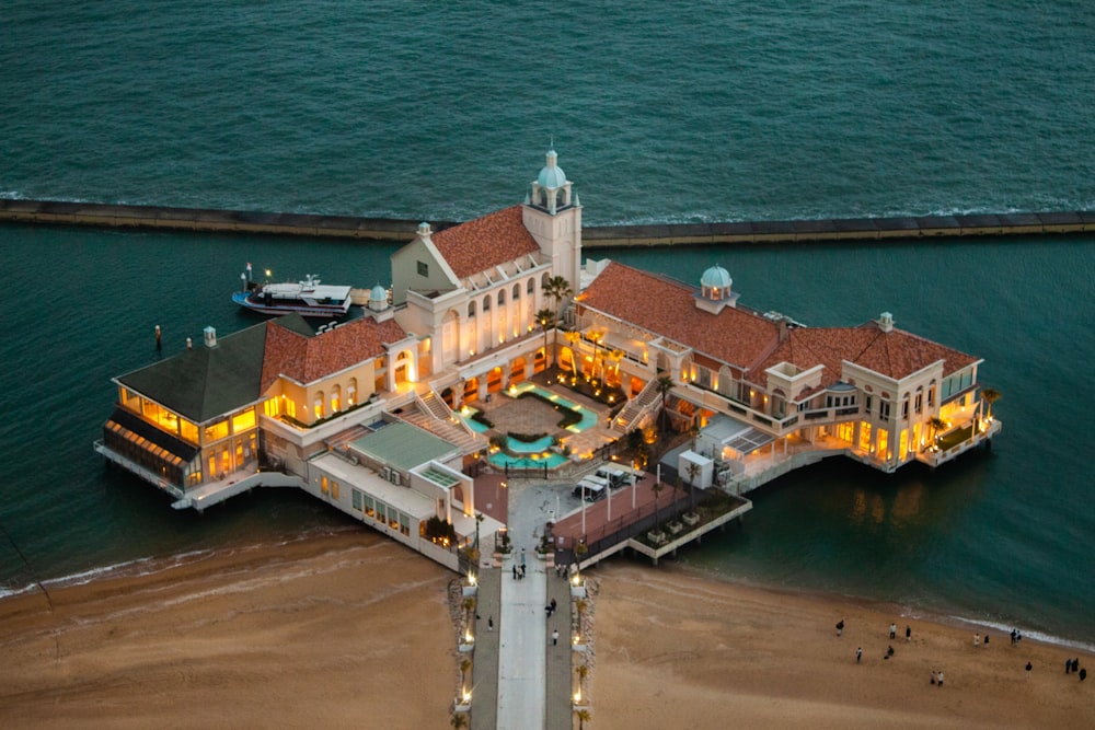 an aerial view of a mansion on the beach