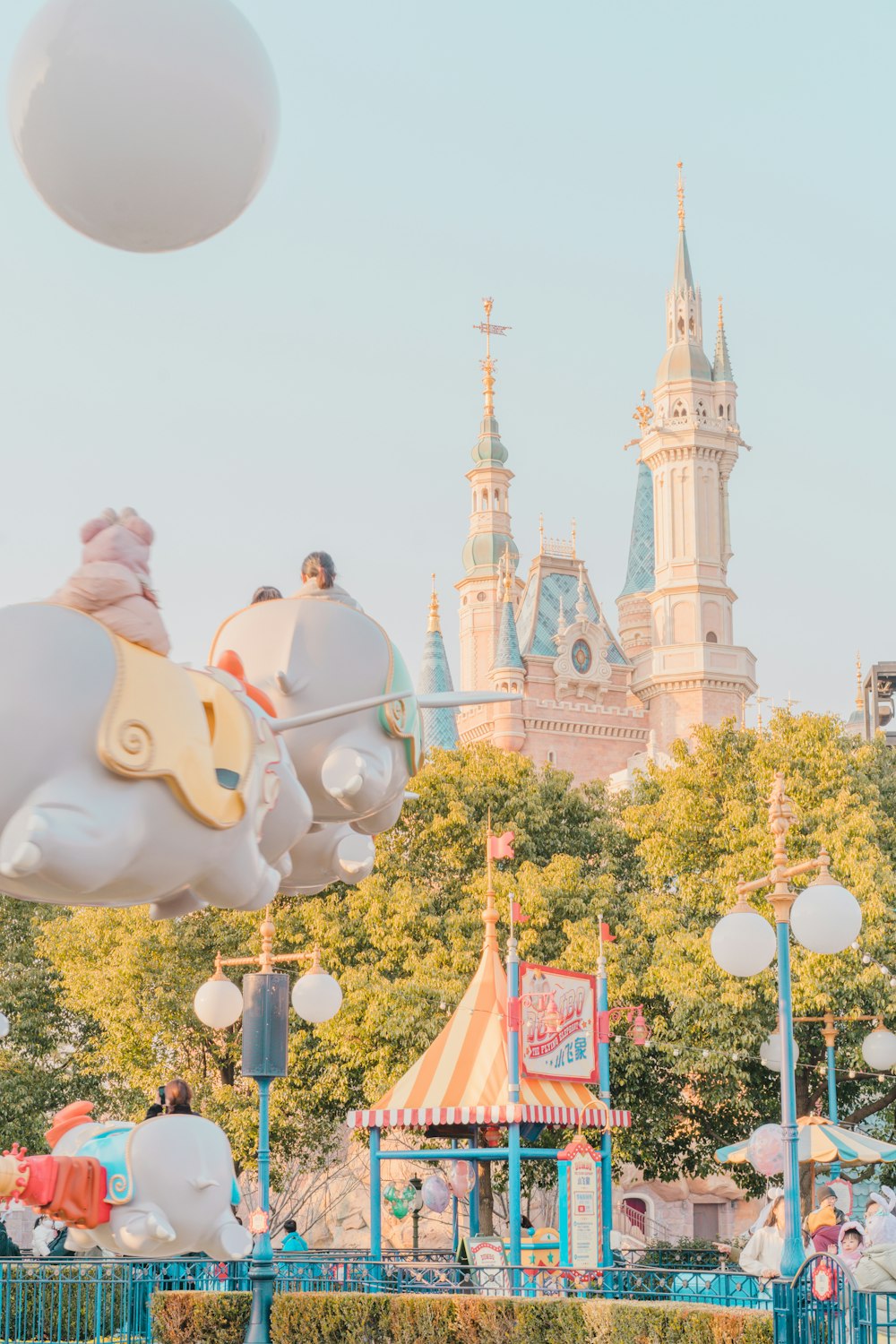 an amusement park with a castle in the background