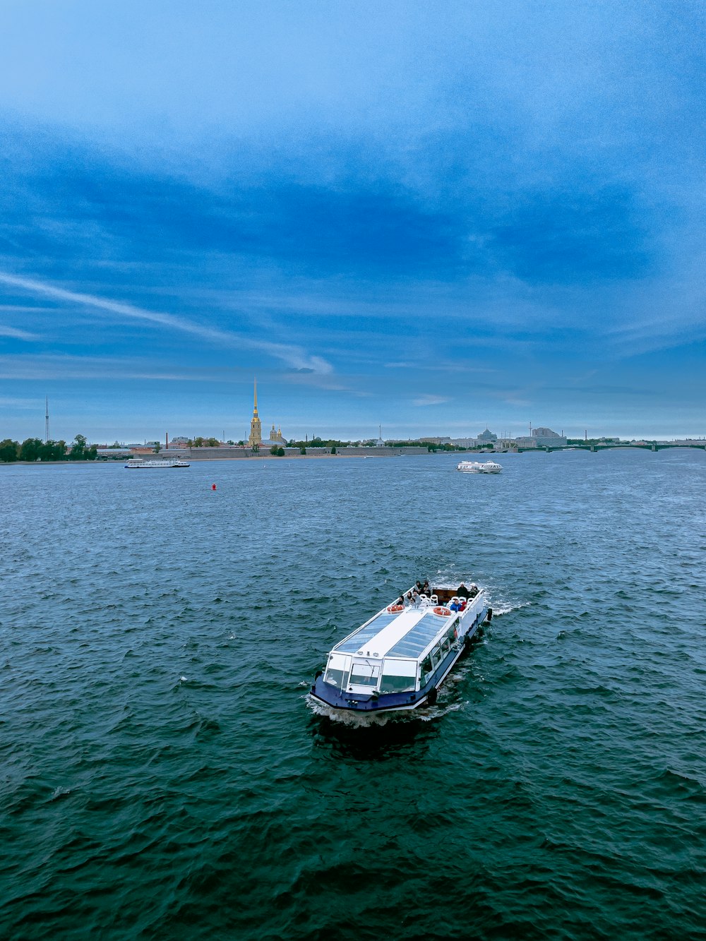 a white boat floating on top of a large body of water