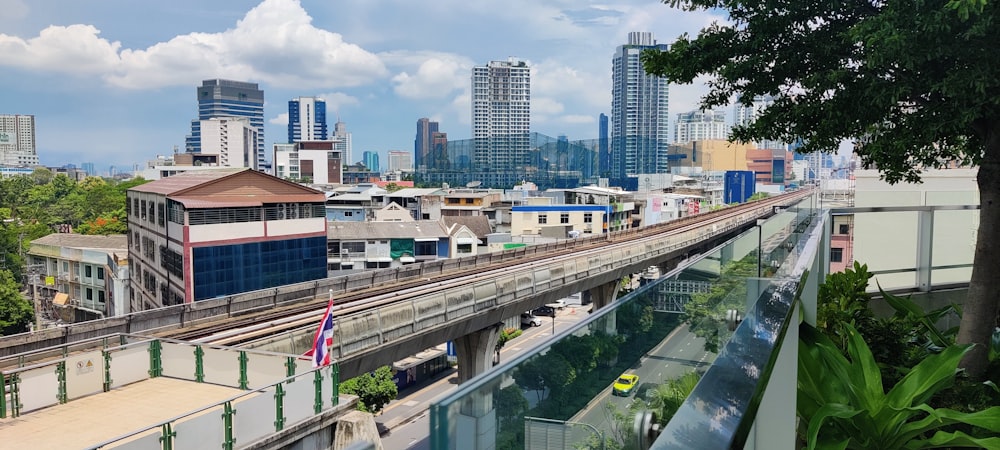 a train traveling through a city next to tall buildings