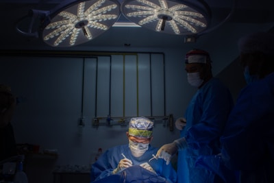 a group of doctors in scrubs in a dark room