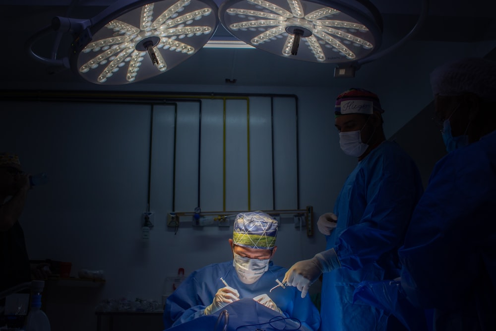 a group of doctors in scrubs in a dark room