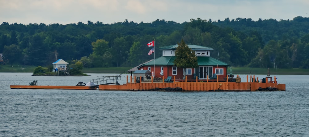 a house sitting on top of a lake next to a dock