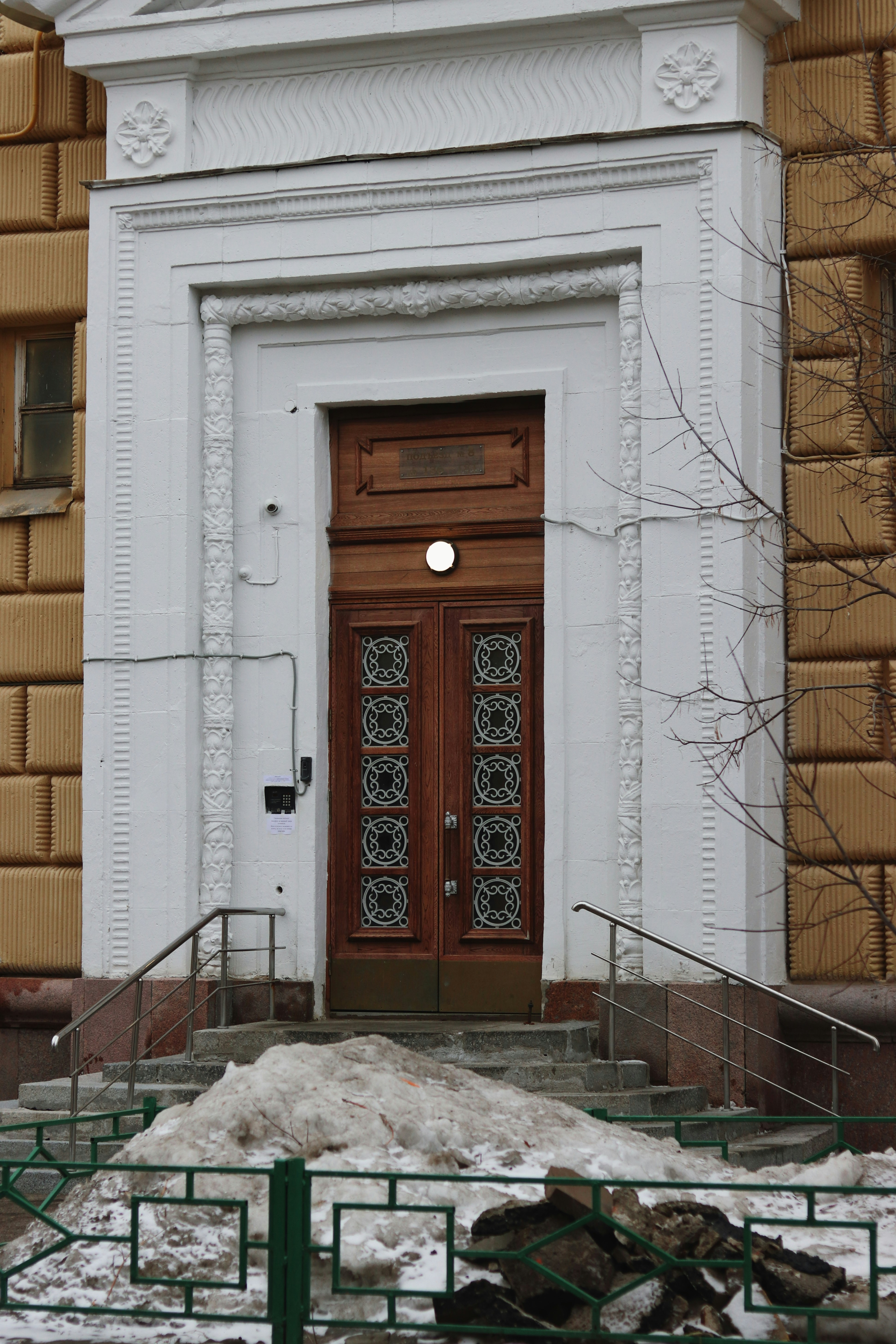 a large white building with a wooden door