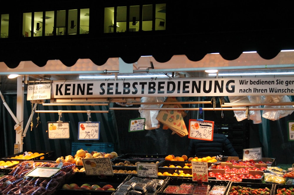 a fruit stand with various fruits and vegetables