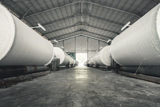 a warehouse filled with lots of large white pipes