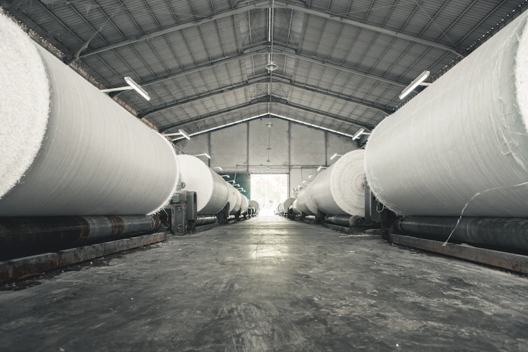 a warehouse filled with lots of large white pipes