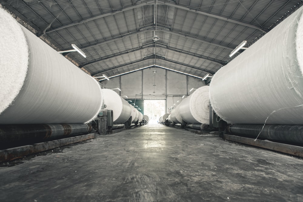 a warehouse filled with lots of large white pipes