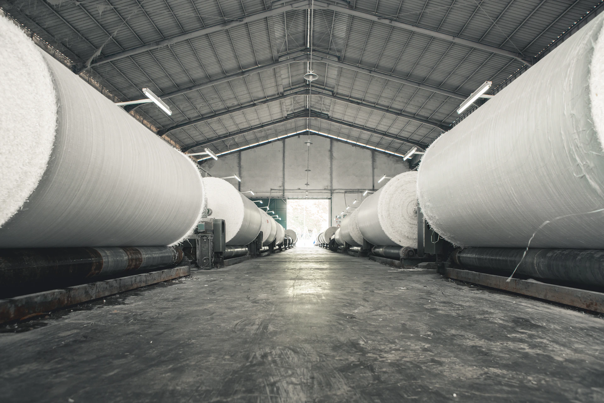 a warehouse filled with lots of large white pipes