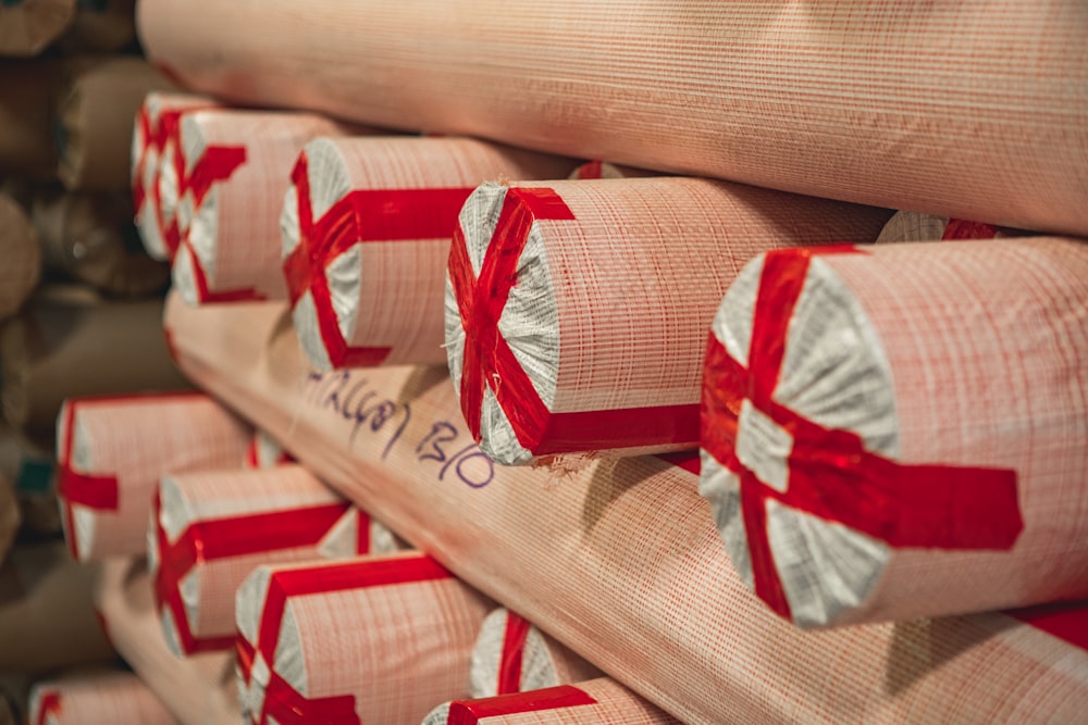 a stack of firewood wrapped in red ribbon
