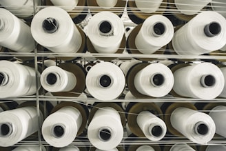 Close-up of durable fiberglass cloth rolls stacked in a factory.