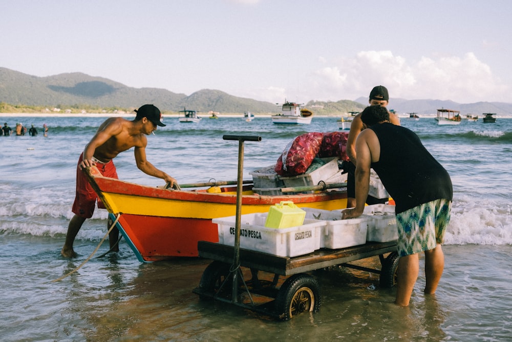 a man pushing a boat out of the water