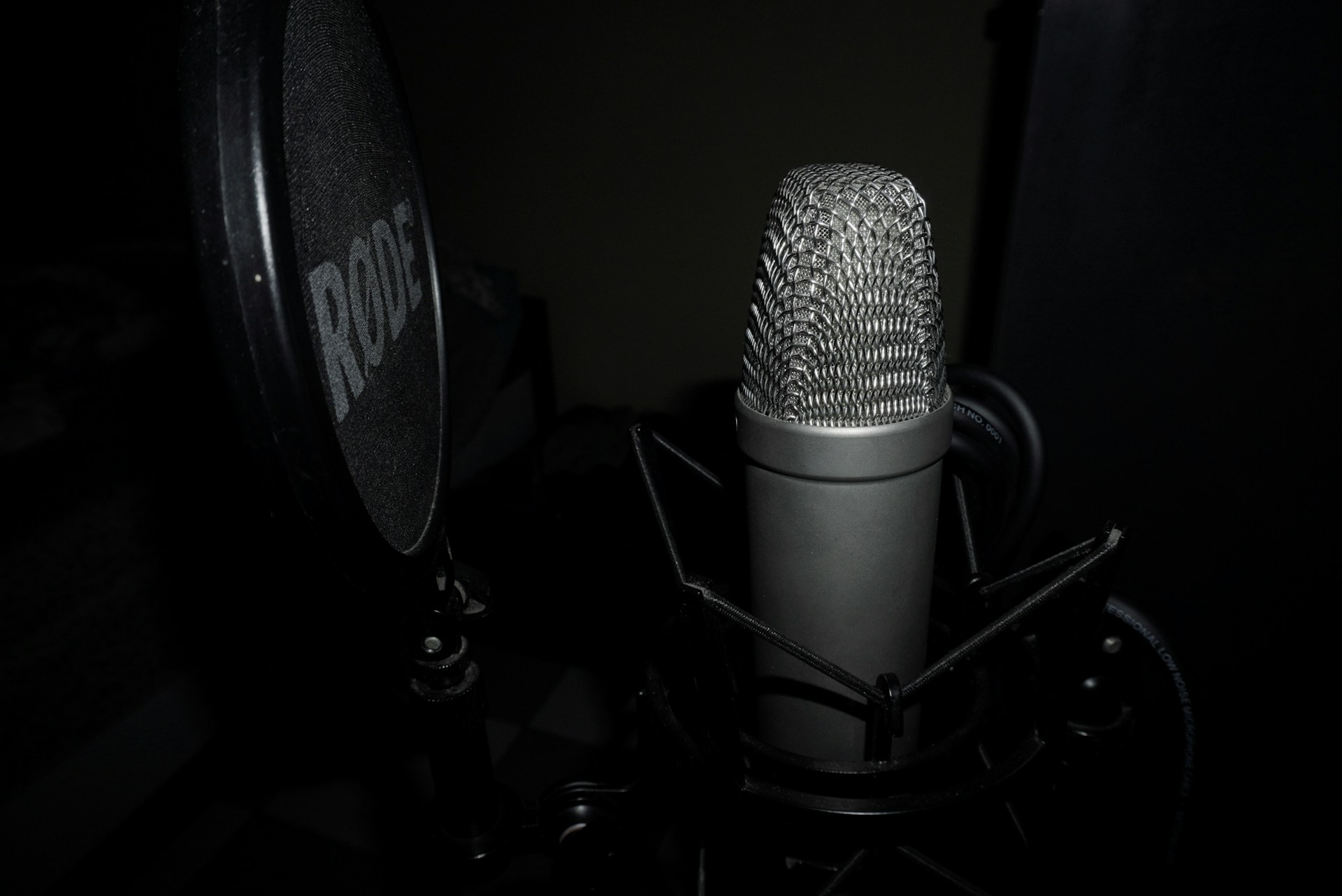 a microphone in a dark room with a black background