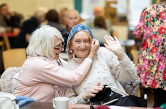 two older women sitting at a table together