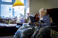 a woman sitting in a chair reading a book