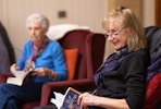 a woman sitting in a chair reading a book