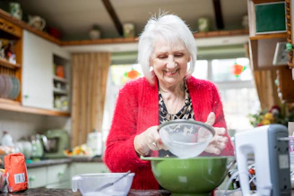 a woman mixing a bowl in a kitchen