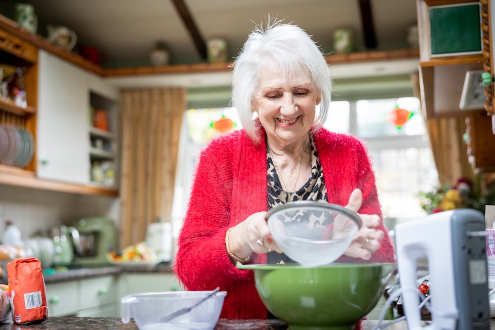 a woman mixing a bowl in a kitchen