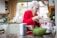Happy woman baking a cake in a cozy kitchen.