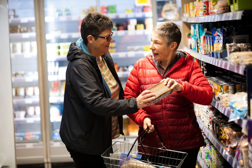 a man and a woman shopping in a grocery store