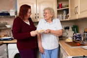 two women standing in a kitchen next to each other