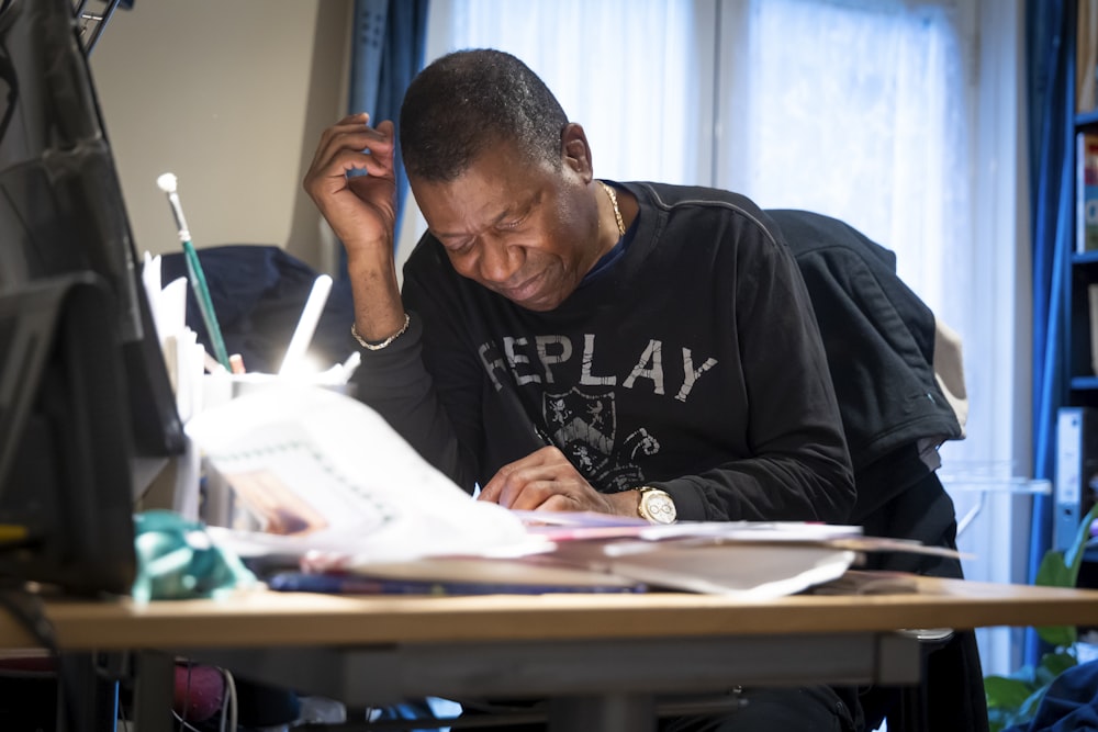 a man sitting at a desk working on a computer