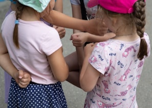 A group of diverse children engaging in a supportive activity.