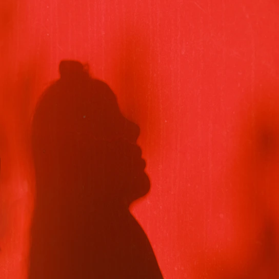 A striking silhouette of a focused man against a charcoal background with sharp gold accents symbolizing strength and determination.