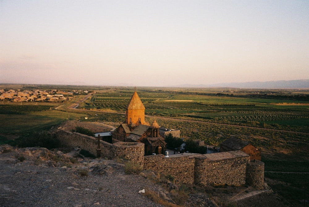 an old castle in the middle of a field