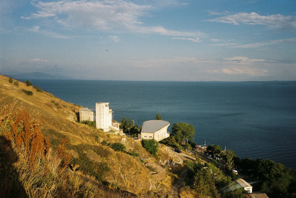 a house on a hill overlooking a body of water